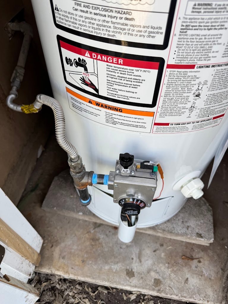Gas water heater with pilot assembly serviced on site